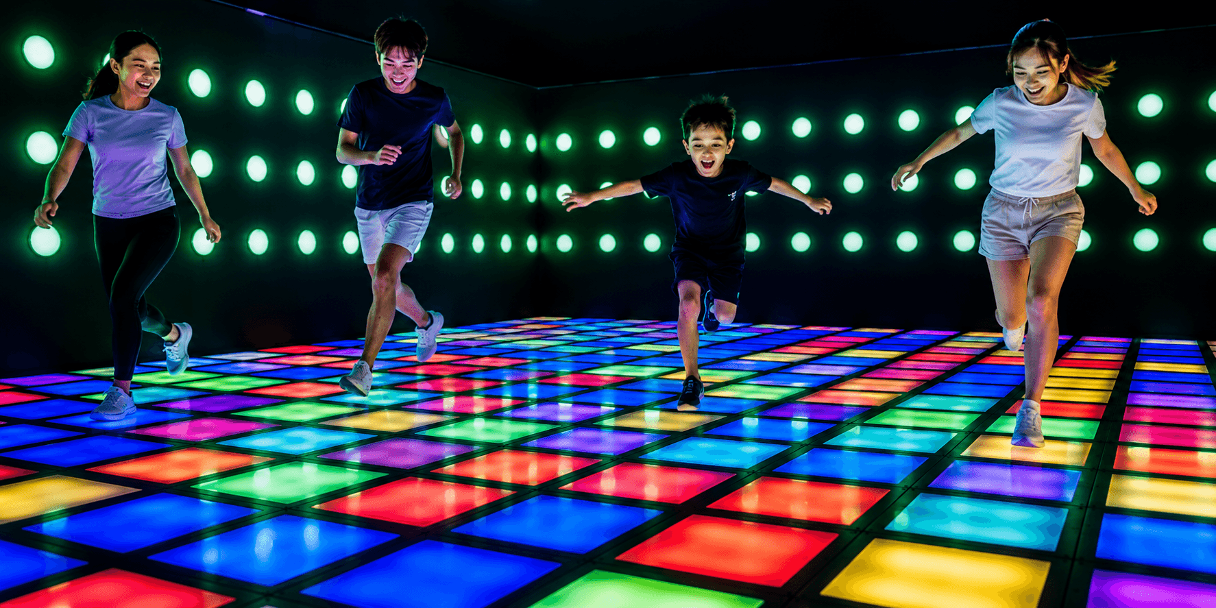 Guests playing on an interactive glow floor